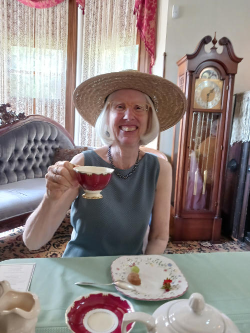 woman smiling at tea smj house